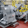 PRAB chip processing system with conveyor handling metal scrap in manufacturing facility