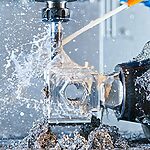 CNC drilling operation generating recyclable metal scrap and coolant