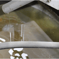 Recycled coolant collected in pan after chip wringer separation